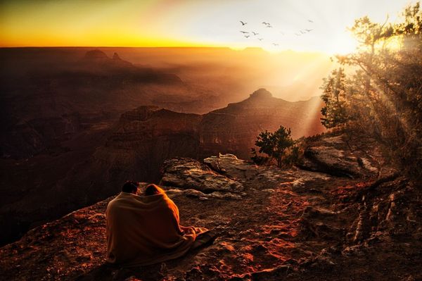 Couple at sunrise, Grand Canyon National Park, USA