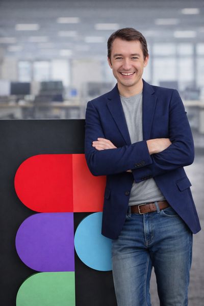 Leo Vogel smiling next to a large Figma logo installation at Config, Figma's annual design conference